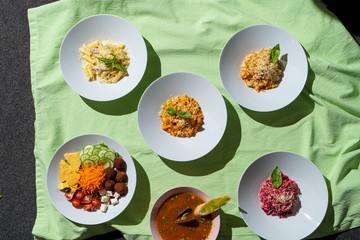 Menu photography: top view of different restaurant meals on bright cloth background