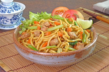 Vegetarian food : stir fried noodle with tofu, carrots and green vegetables. Chinese vegetarian noodle for vegetarian festival.