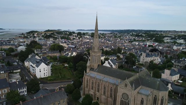 Aerial view. Flying around Catholic Cathedral of Notre Dame in the town of Paimpol in Northern France, in Brittany.