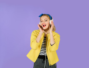 Woman enjoy good sound. Girl relaxing listening to favorite modern music with headphones. Happy music woman with earphones. Woman with headphones listening music. Beautiful sexy girl in yellow jacket.