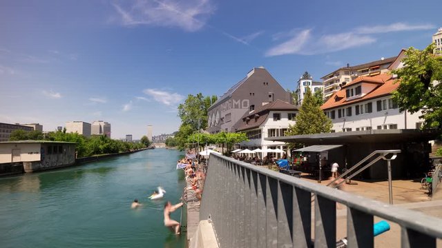 sunny day zurich city center famous river bridge swimming fun panorama 4k timelapse switzerland