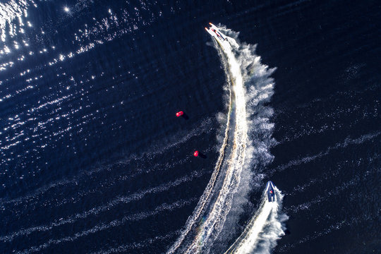 Powerboat racing from above isolated on dark water background.