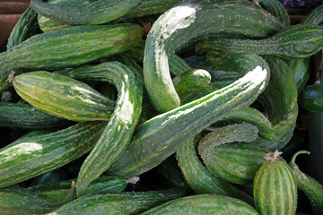 Close-up full frame view of freshly harvested organic curved squash displayed at a market stand