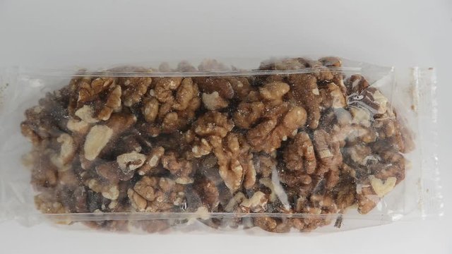 young gray moth insect crawling and flying into transparent package with walnut, close up full HD stock video footage in real-time