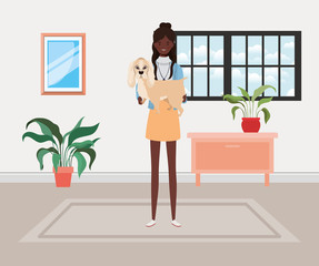 young afro woman lifting cute dog indoor the house