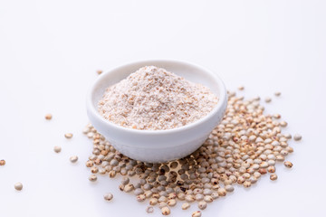 Uncooked raw Sorghum flour (also known as sorgo) in a white bowl, isolated on white background