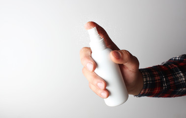 spray gun in hand on gray background