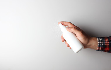 spray gun in hand on gray background