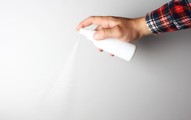 spray gun in hand on gray background