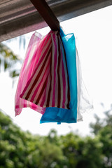 Colorful plastic bags hanging under the roof.