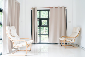 Wooden armchair sofa in modern room with curtain on glass wondow