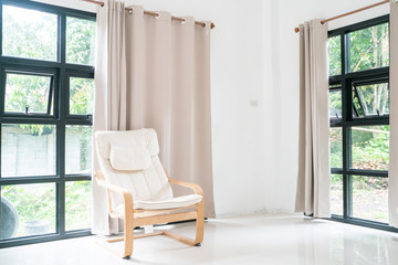 Wooden armchair sofa in modern room with curtain on glass wondow