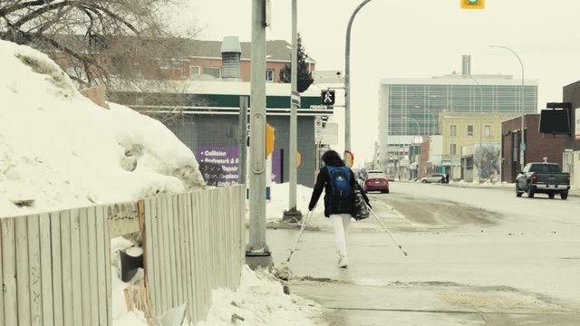 A handicapped poor woman jaywalking in a bad neighbourhood