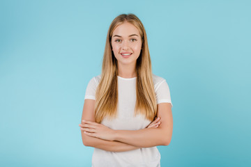 Fototapeta premium smiling friendly blonde girl isolated over blue