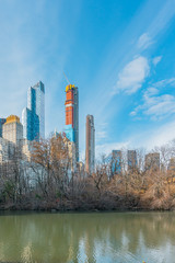 Fototapeta premium New York City, NY, USA - 25th, December, 2018 - Beautiful Architecture Skyline Buildings view in a cold sunny day in Central Park at the lake near Gapstow Bridge.