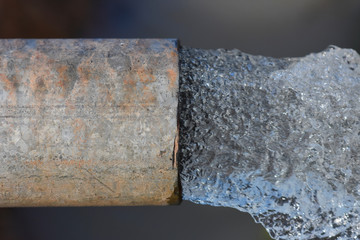 Old and rusty pipe with flow out water.