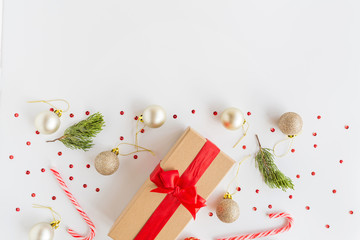 Christmas composition. Wrapped gift, wooden toys lying on white background. new year concept. Greeting card, winter holidays, xmas celebration 2020. Flat lay, top view, copy space, mockup, template