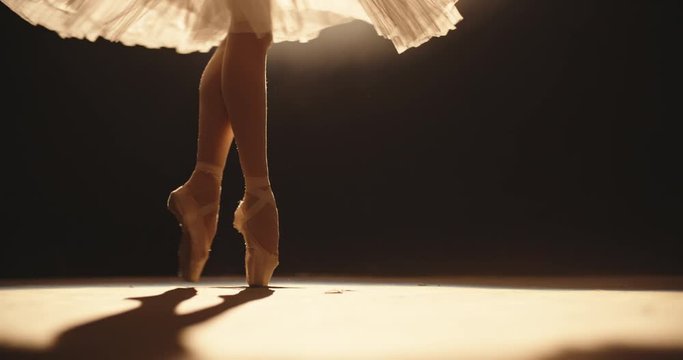 Beautiful ballet choreographer having a performance on theatre stage, dancing while spotted by bright light - arts concept 4k footage
