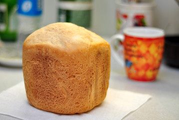 Fototapeta na wymiar A loaf of fresh bread lies on the table, shallow depth of field