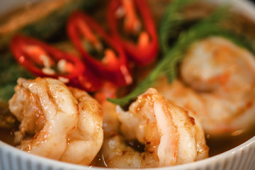 food background of Thai style food set menu of spicy and sour yellow curry with acacia vegetable omelette served with deep fried chicken wing sticks, rice and variety of fresh vegetable