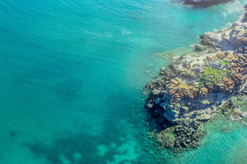 Naklejka na ściany i meble overhead tropical beach coastline with rocks