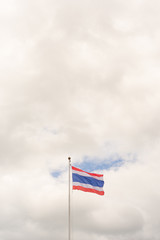 Flag of Thailand on on pole with white clouds and blue sky. Copy space wallpaper.