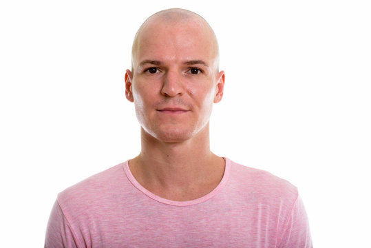 Studio shot of young handsome bald man
