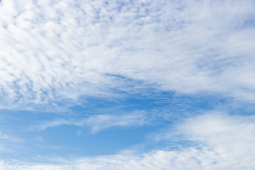 Clear blue sky with white cloud background