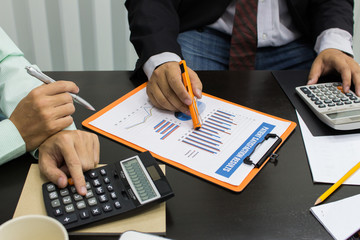 Business man Writing expense information in home office.team work concept