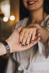 woman's hand with an engagement ring