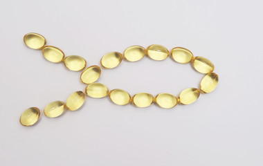 Fish fat in capsule on light background.