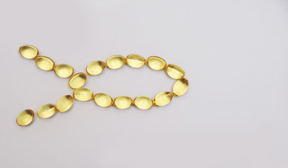 Fish fat in capsule on light background.