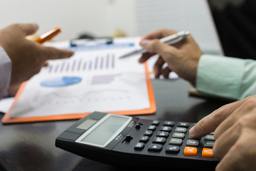 Fototapeta premium Business man Writing expense information in home office.team work concept