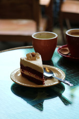 cup of coffee and cake on table