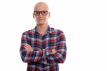 Fototapeta premium Studio shot of young handsome bald man wearing eyeglasses with a