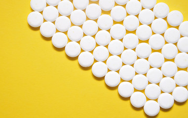 Drugs on yellow background. Health care concept.