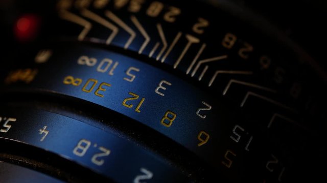 a black lens that turns a aperture.