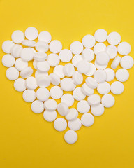 Drugs on yellow background. Health care concept.