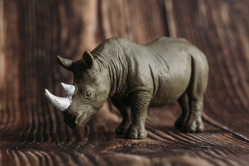 Fototapeta premium figure of a toy Rhino on a wooden background