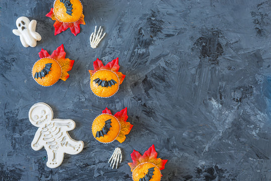 Halloween Pumpkin Cupcakes Served On Black Background, Top View