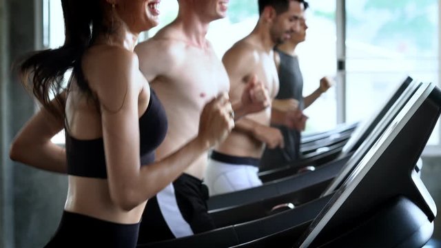 4K Group of sweaty athletic sport man and woman teamwork in sportswear do cardio workout exercise by jogging running on treadmill in training class at fitness gym for diet and healthy lifestyle