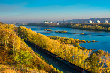 railway along the river in autumn