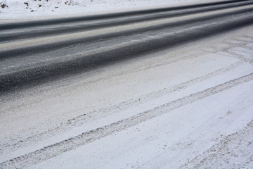 The tread marks of car tires on winter road. © Ольга Васильева