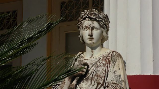 The statue of the Muse of Melpomene with a tragic mask in his hands. Corfu island, Greece.	