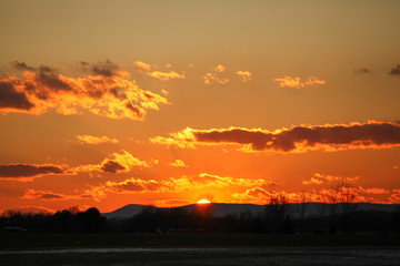 Orange sky sunrise with layers of clouds