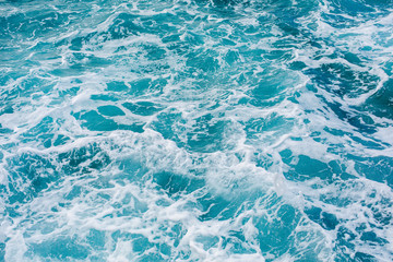 Fototapeta na wymiar Turquoise sea surface background with splashing waves