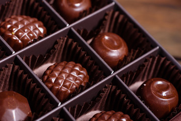 Assortment of fine chocolate candies, white, dark, and milk chocolate sweets background. Copy space. Top view. An assortment of fine chocolates in white, dark, and milk chocolate