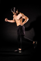 sport man running and and showing muscle bodybuilding on black backgrounds, fitness concept, sport concept