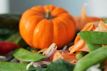 bright orange pumpkin with salad mix on blurred background