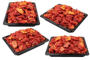Marinated meat in a black plastic container Ready for sale. White isolated.